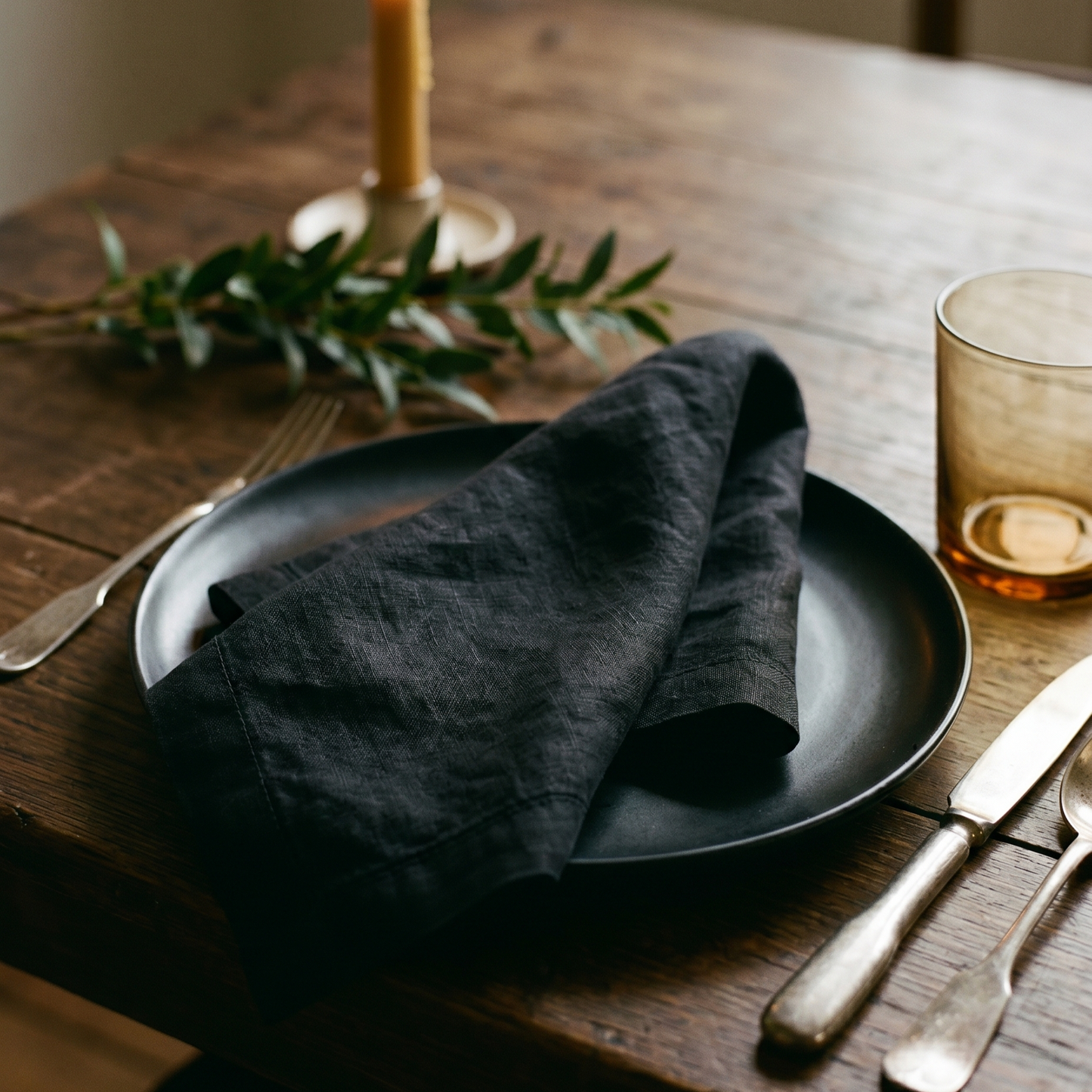 Black plain linen napkin styled at a table place setting