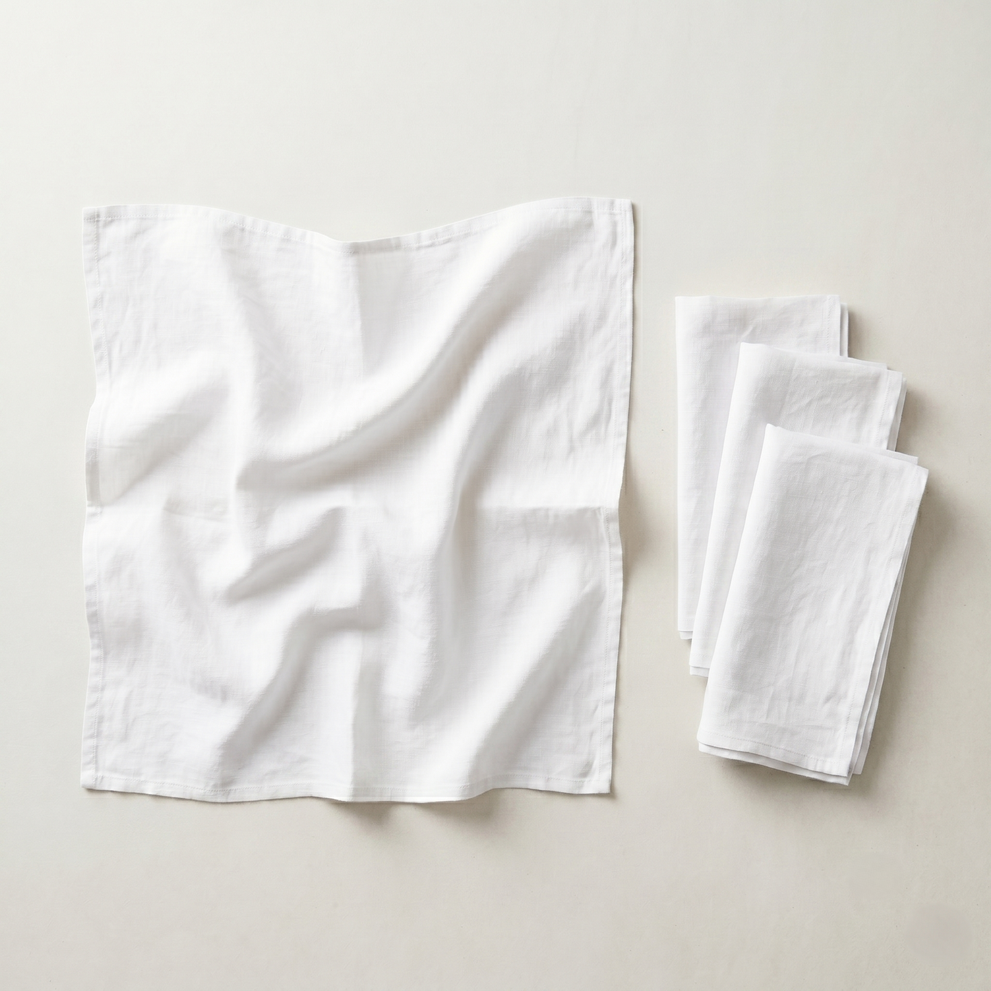 Stack of four folded ivory plain linen napkins in soft pure linen