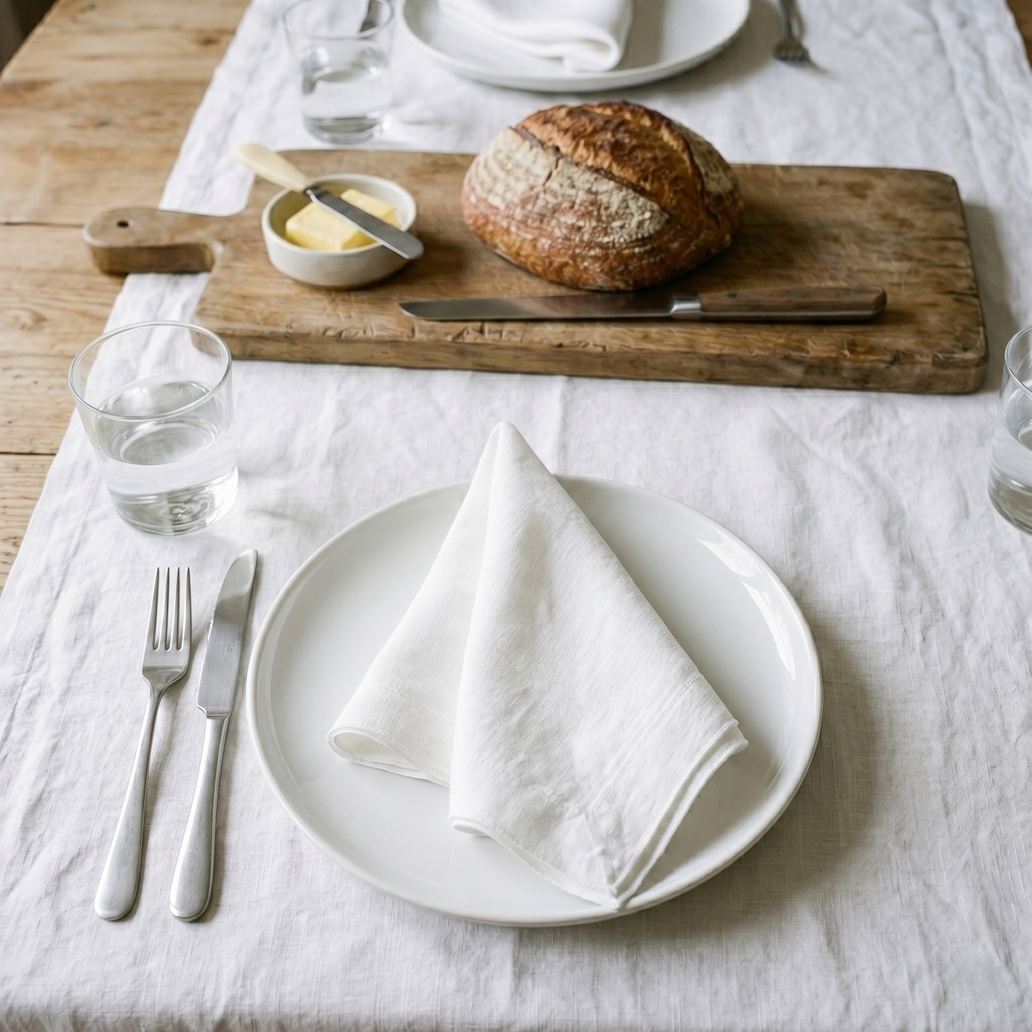 White plain linen napkin styled with complementary tableware